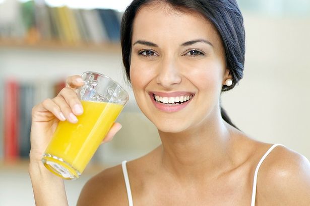Woman-drinking-orange-juice.png